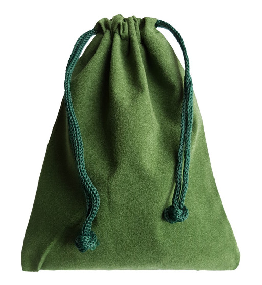 Green colored drawstring velveteen bag shown closed holding a stone rune set.