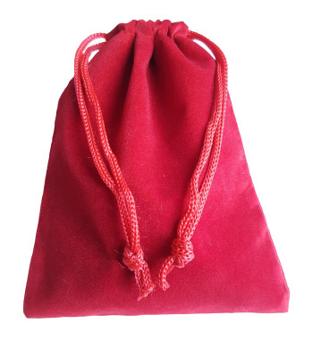 Red colored drawstring velveteen bag shown closed holding a stone rune set.