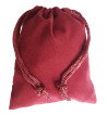 Small burgundy colored drawstring velveteen bag shown closed holding a stone rune set.