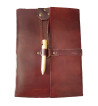 Brown leather medieval journal has a fold over cover with loop and wooden peg closure.