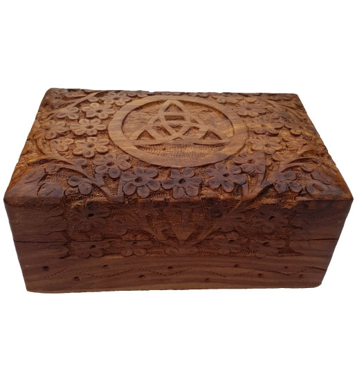 The Floral Triquetra Box is a wooden box with a carved floral pattern surrounding a triquetra.