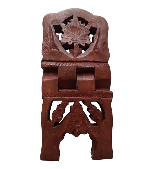 The wooden book stand has carved out designs on the arms and legs.