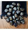 Black Jasper runes feature gold colored Elder Futhark runes.  Each set comes with a black velveteen rune pouch.