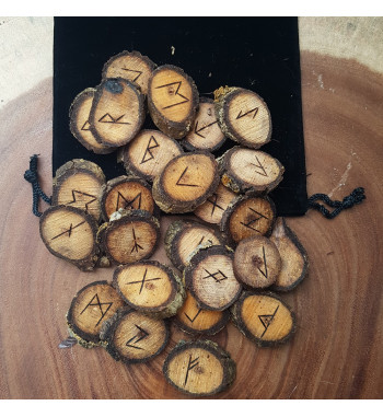 Walnut rune set featuring the Elder Futhark burned onto slices of a Walnut branch. Rune set comes with a black velveteen pouch.