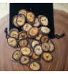 Walnut rune set featuring the Elder Futhark burned onto slices of a Walnut branch. Rune set comes with a black velveteen pouch.