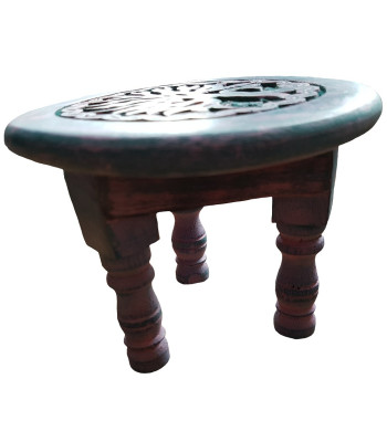 Carved with an image of Yggdrasil this green altar table is accented with varying colors.