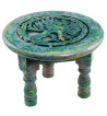 Carved with an image of Yggdrasil this green altar table is accented with varying colors.